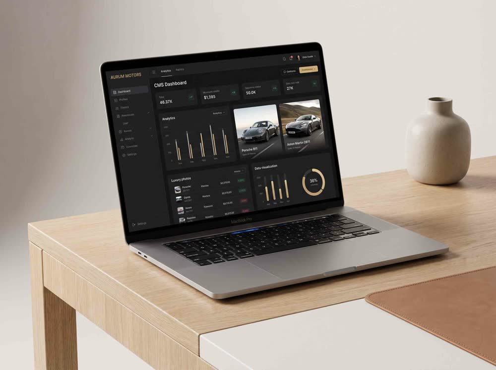 Laptop showing a car dealership inventory dashboard with a Porsche 911 and Aston Martin DB11